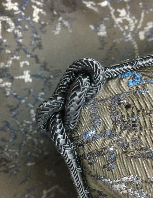Hand applied rope/cord with figure of 8 knot. 